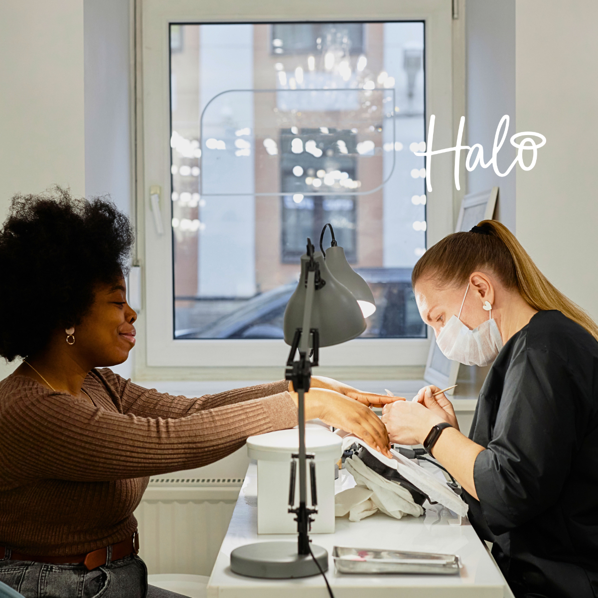 Nail technician giving a client a professional manicure at a nail salon.