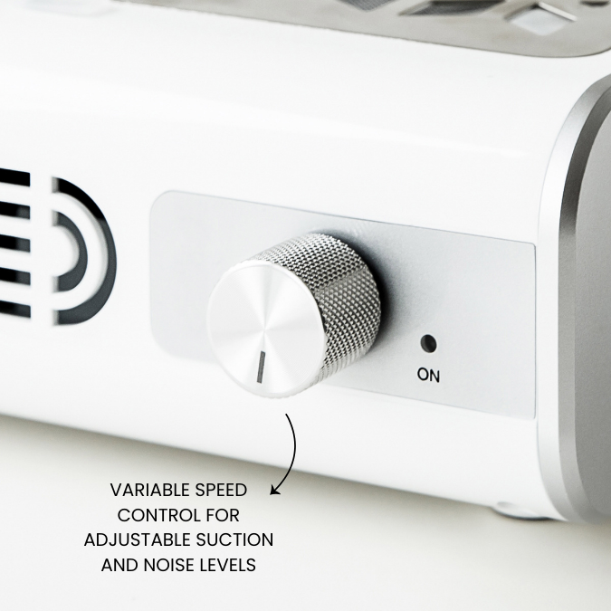 Variable speed control knob on a white appliance with text indicating adjustable suction and noise levels.