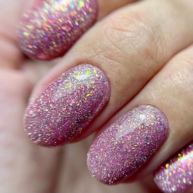 Close-up of a hand with pink glittery nail polish