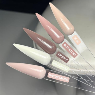 Set of long, pointed nail art tips with color labels on a gradient background