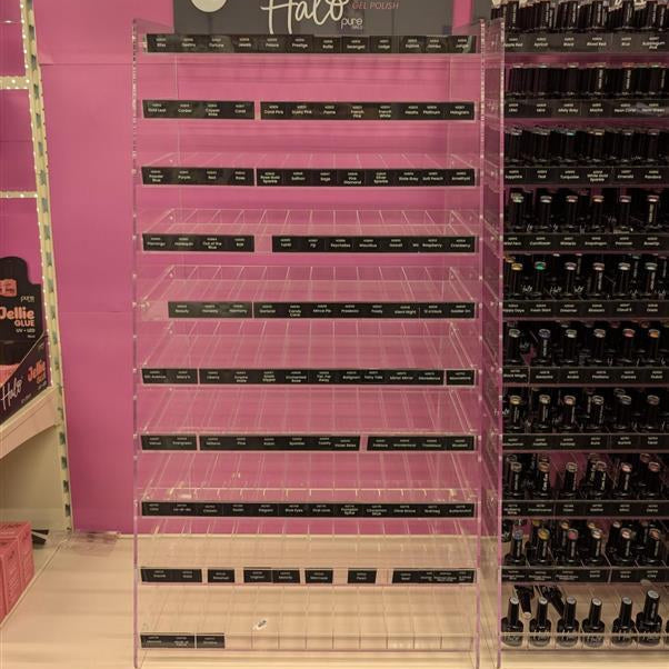Display of nail polish bottles with 'Halo' branding in a store setting.