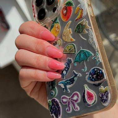 Phone case with colorful embroidered designs held by a hand
