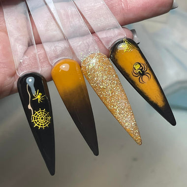 Nail art designs with black, gold, and clear polish on a neutral background