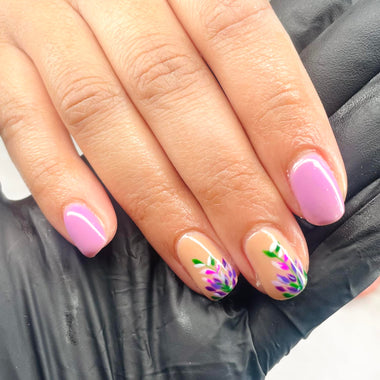 Close-up of a hand with pink nail polish on a gray background