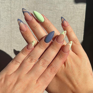 Close-up of hands with pastel-colored nail art on a neutral background