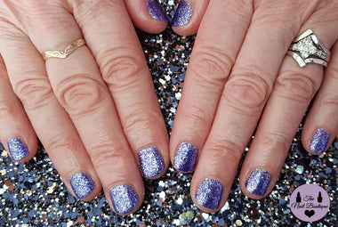 Short gel nails with glittery purple nail polish