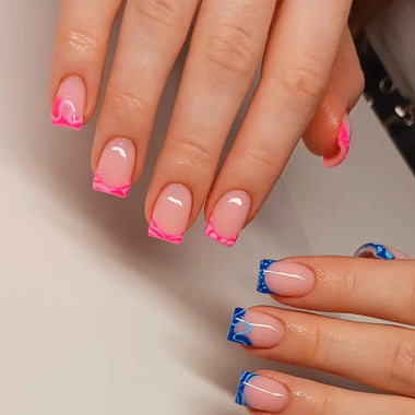 Close-up of hands with pink and blue nail designs on a neutral background