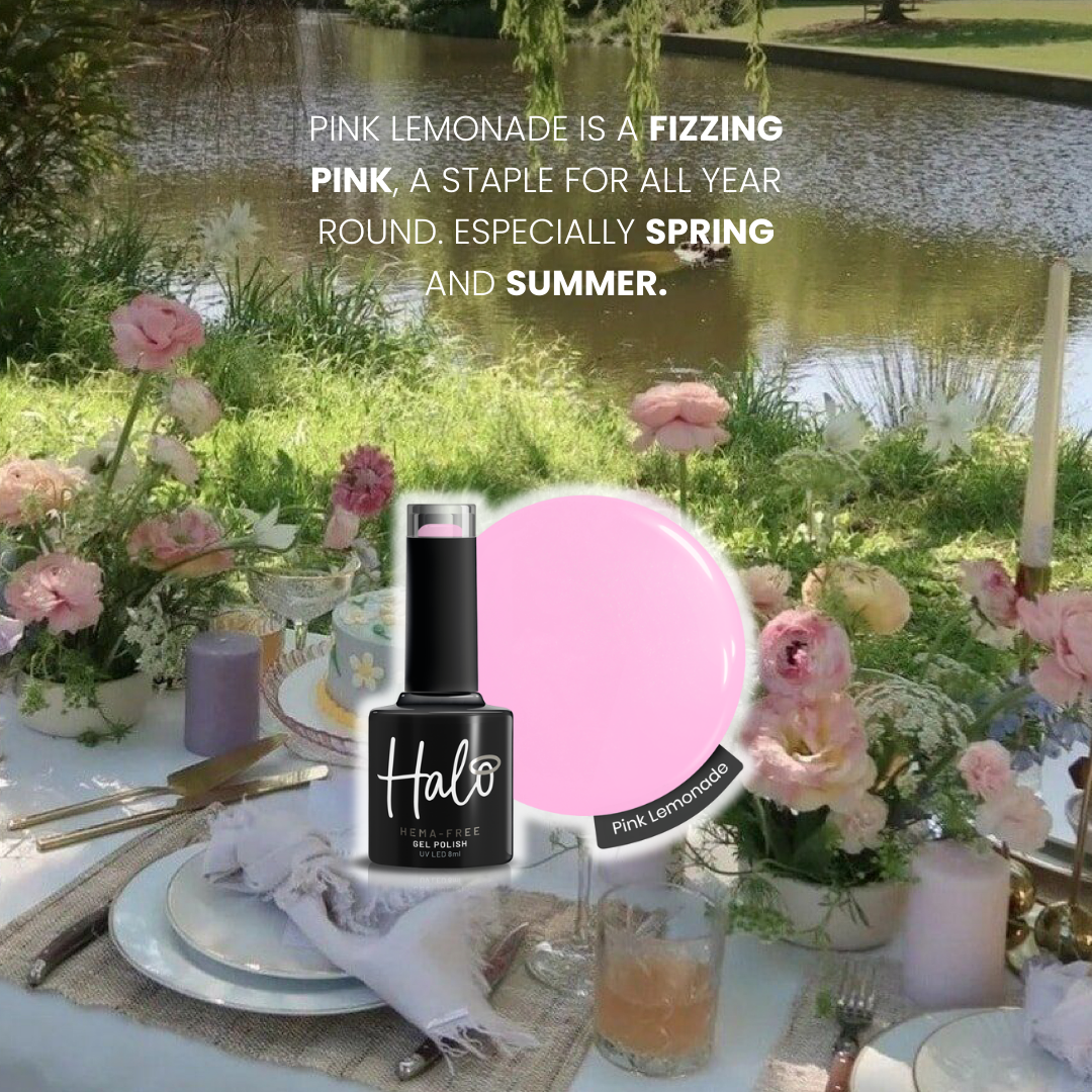 Table setting with pink lemonade bottle and flowers by a pond