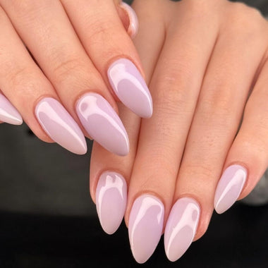 Close-up of hands with light pink nail polish on a dark background