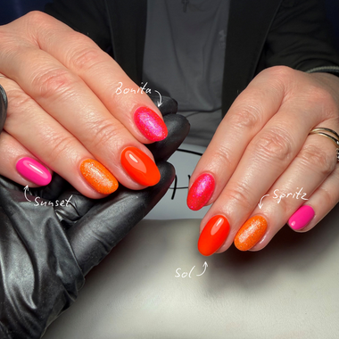 Close-up of hands with colorful nail polish on a neutral background