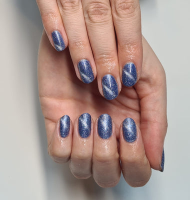 Short oval shaped nails with dark blue glitter nail polish