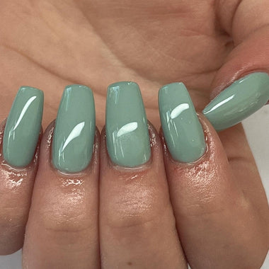 Close up of square nails with blue coloured nail polish