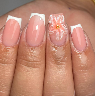 Nail art with a pink flower design on a neutral background