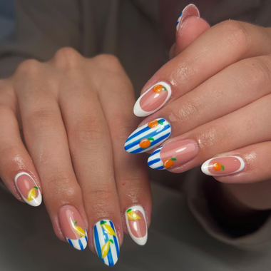 Close-up of hands with colorful nail art on a neutral background