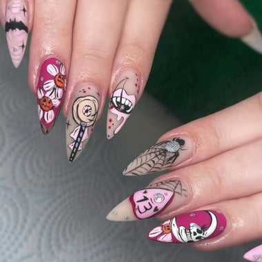 Close-up of a hand with intricately designed nails featuring various patterns and colors.