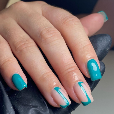 Close-up of a hand with teal nail polish on a neutral background