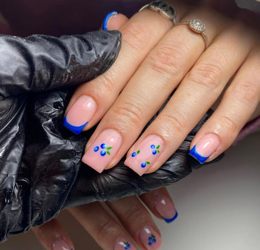 Hand with painted nails wearing a black glove, close-up