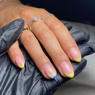 Hand with painted nails wearing black gloves, close-up