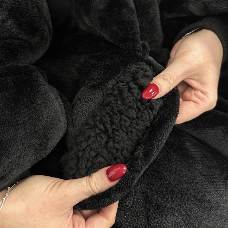 Close-up of hands holding a black textured fabric