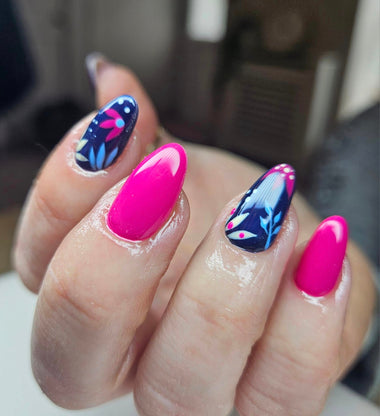 Oval nails with some nails in pink nail color, and others in blue with leafy nail art 