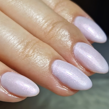 Close-up of a hand with light purple nail polish on a neutral background