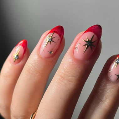 Nails with red and pink design on a neutral background