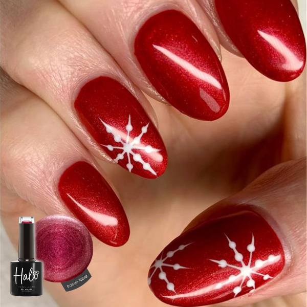 Red nail polish with white snowflake design on nails, Halo nail polish bottle visible.