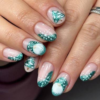 Close-up of hands with Christmas-themed nail art featuring green and white decorations.