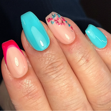 Close-up of a hand with colorful nail art on a dark background