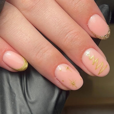 Close-up of a hand with pink nails and gold accents, wearing a black glove.