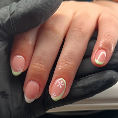 Hand with painted nails wearing a black glove