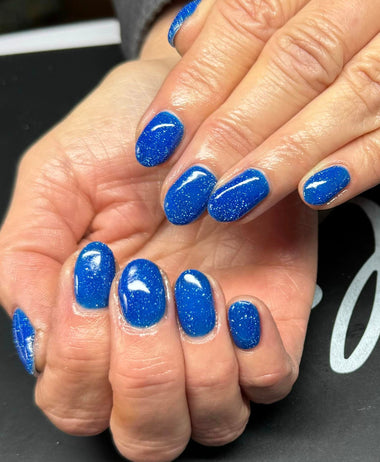 Blue glitter nail design using the Halo gel polish shade 'Gala'