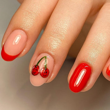 Nail art with red cherries on a neutral background
