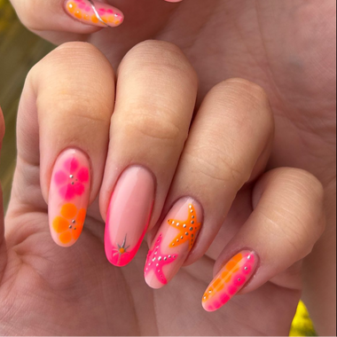 Close-up of a hand with pink and orange floral nail art.