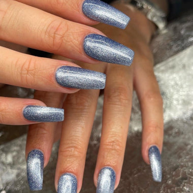Long square shaped nails with dark blue glitter nail polish