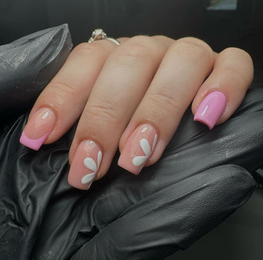 Hand with pink and white floral nail design wearing a black glove - Bubblegum Pink Halo Gel Polish