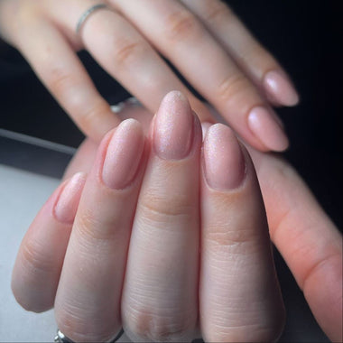 Close-up of hands with neatly manicured nails on a neutral background