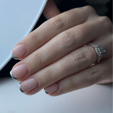 Close-up of a hand with a ring on a light background
