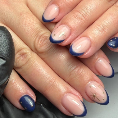 Close-up of hands with blue and beige nail design