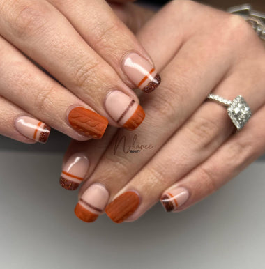 Short nails with dark orange and brown nail designs