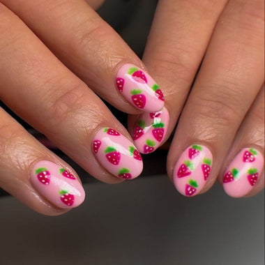 Nails with strawberry design on a dark background