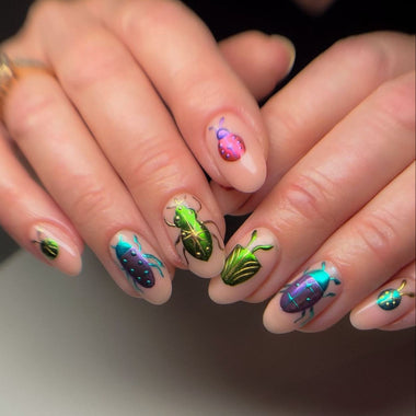Nails with beetle design on a neutral background