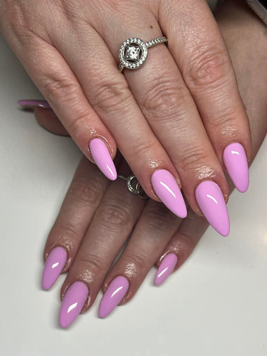 Long stiletto nails in a light pink polish